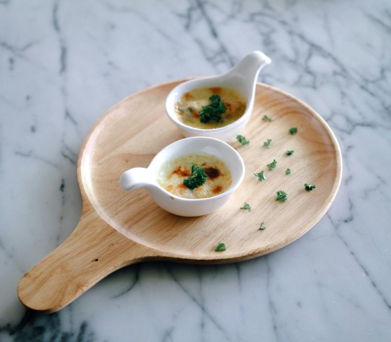 High-quality food photo of tomato soup with herbed crème fraîche, plated fine dining style, clean background – small size